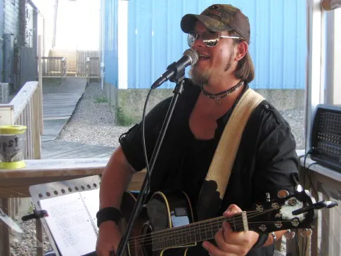 Live musician performing on the deck